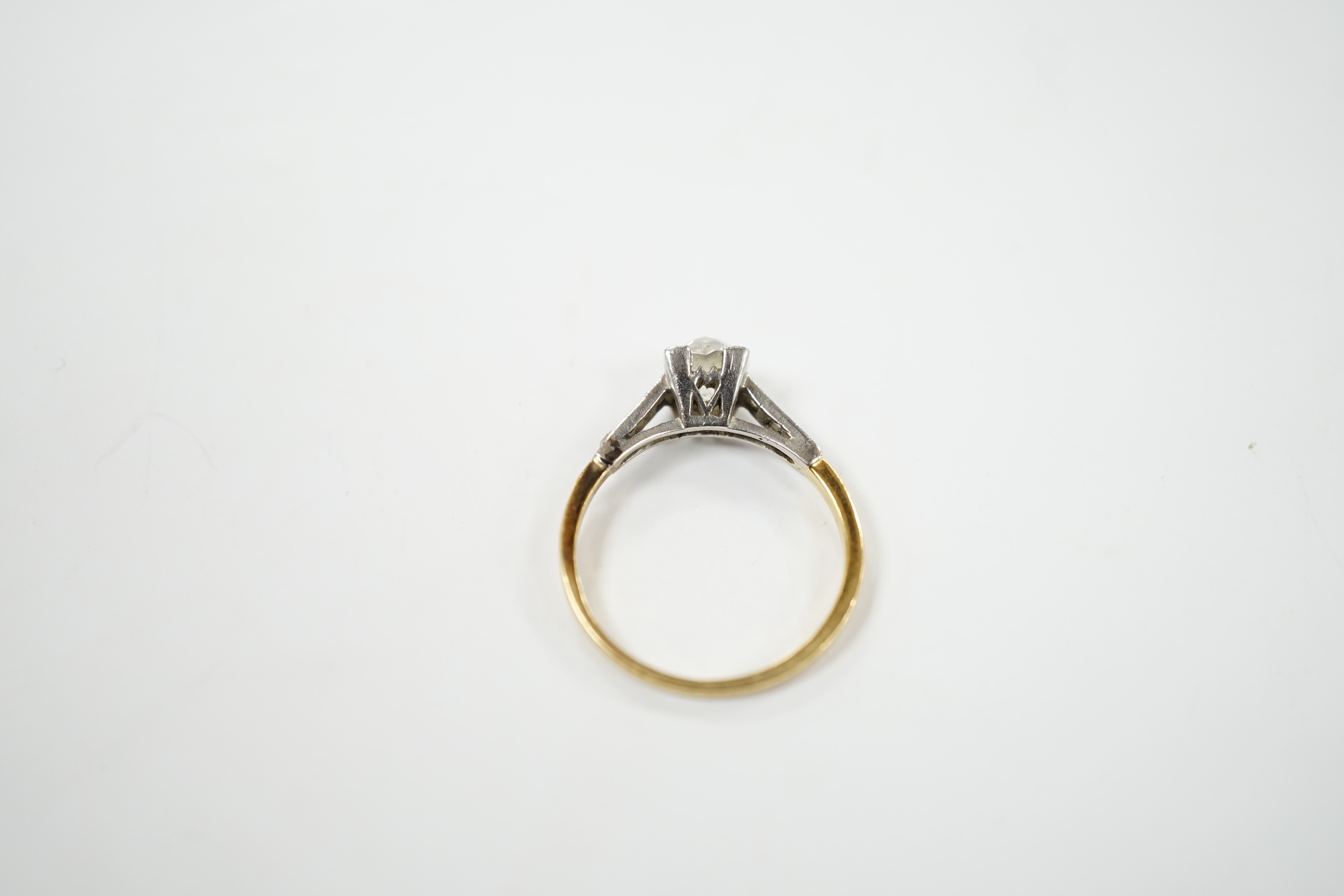 A 1920's yellow metal and single stone old mine cut diamond set ring, with six stone diamond set shoulders, size K/L, gross weight 2.2 grams.